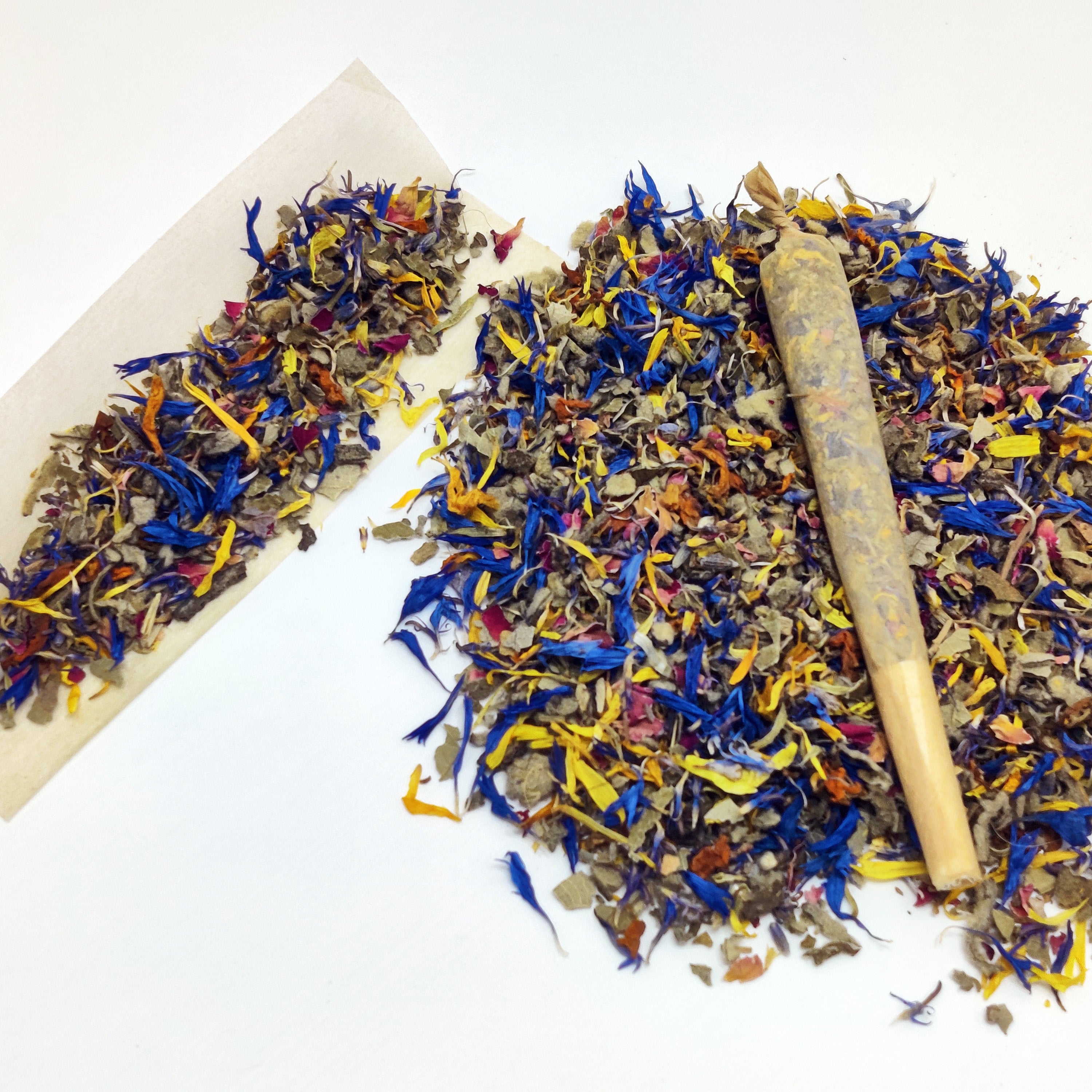 Colorful dried flower blend with a wooden rolling pin on a white background