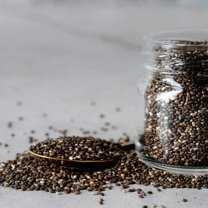 Organic chia seeds in a glass jar and spoon, rich in omega-3, fiber, and protein for healthy diet and superfood nutrition