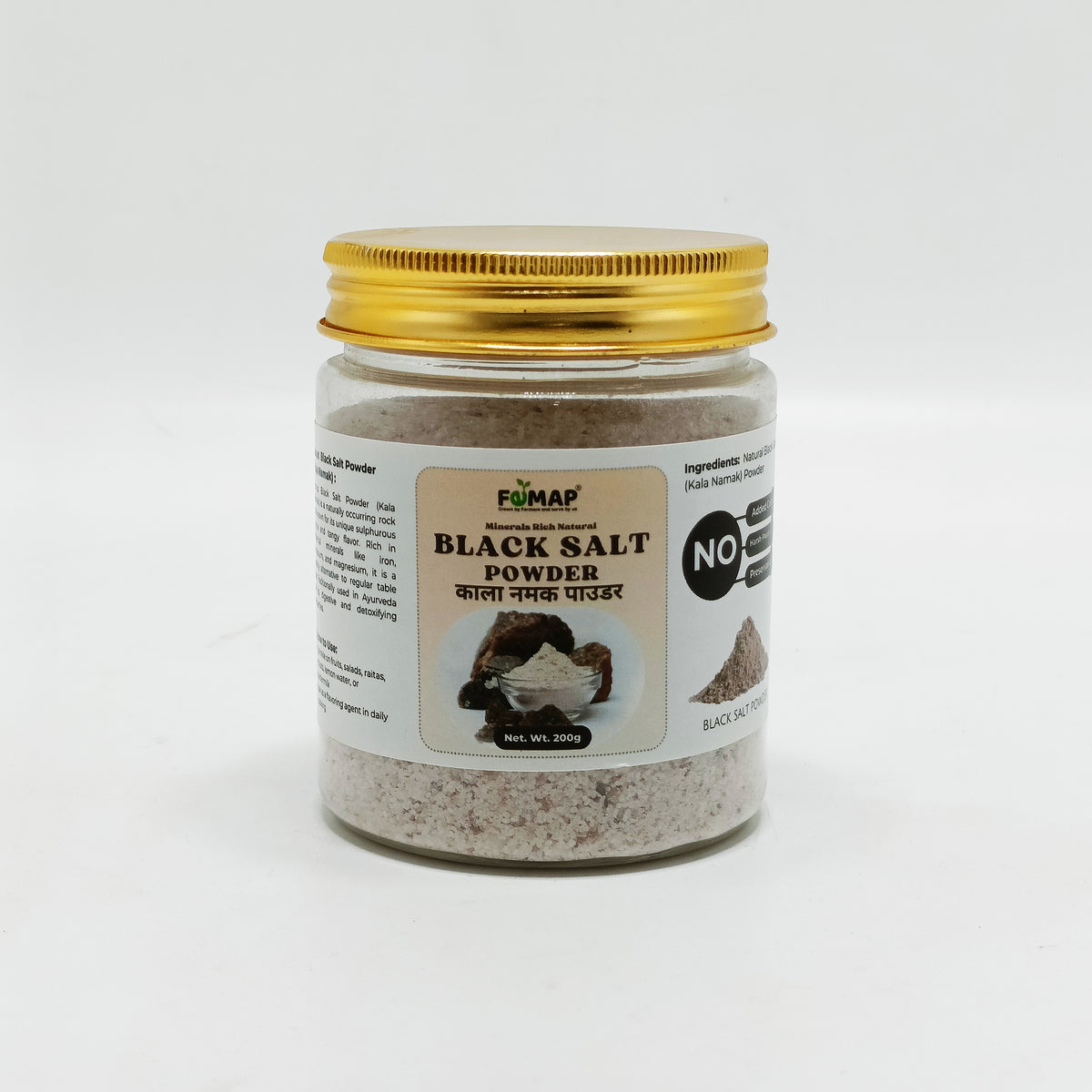 Jar of black salt powder with a gold lid on a white background