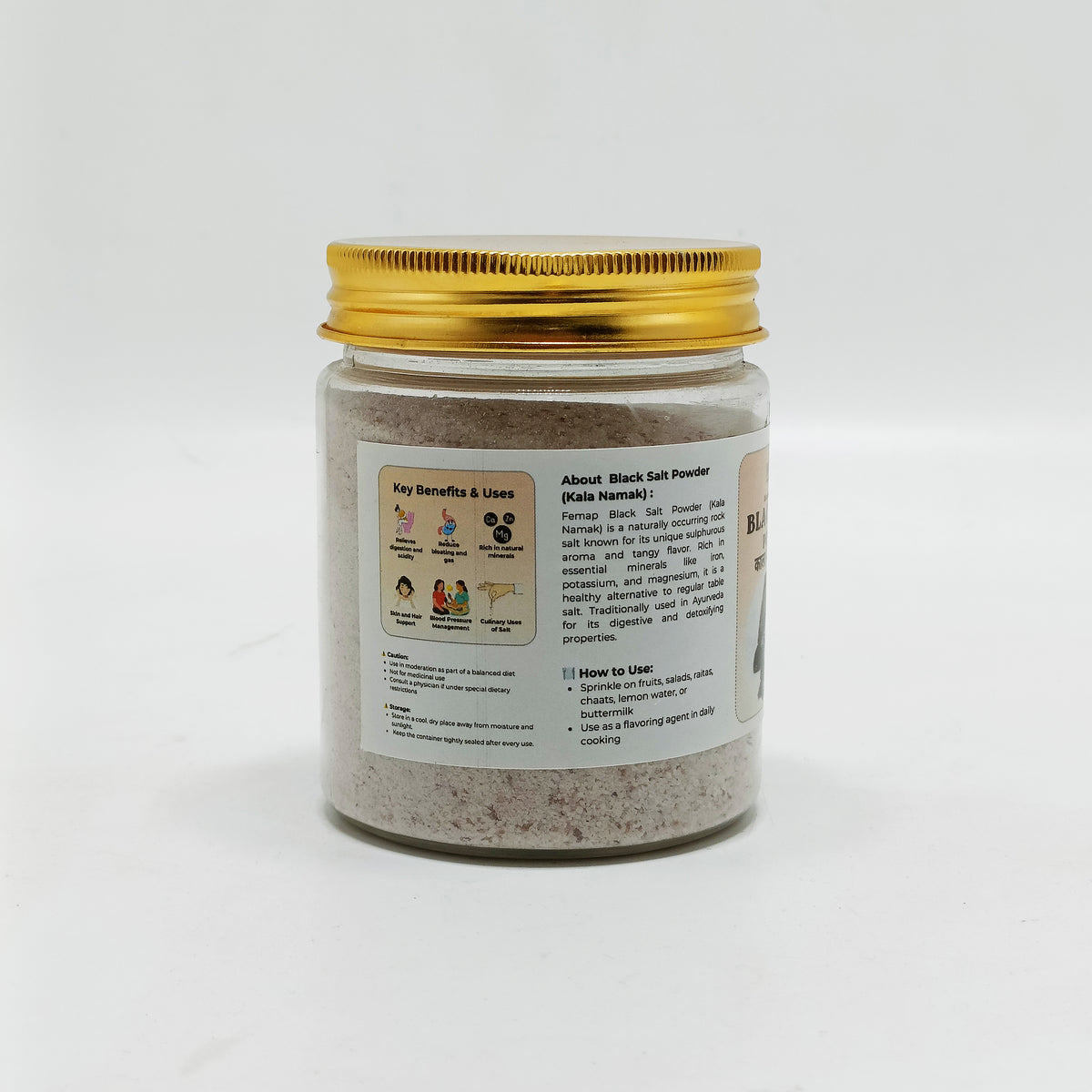 Jar of black salt powder with a gold lid on a white background