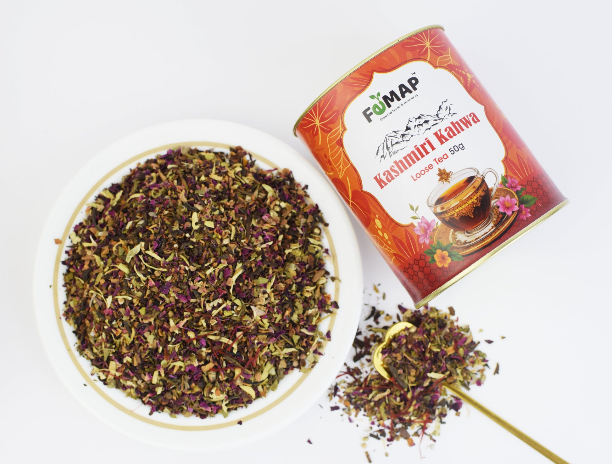 Top view of FEMAP Kashmiri Kahwa Loose Tea 50g – vibrant herbal blend with rose petals, green tea leaves, and spices in white bowl next to product tin