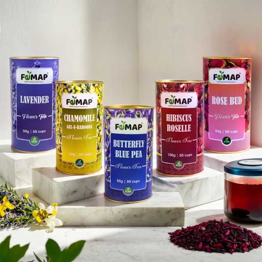 A selection of five different FEMAP branded floral teas, each in a distinctively colored tin canister. The teas include Chamomile, Hibiscus, Lavender, Rose, and Blue Tea.