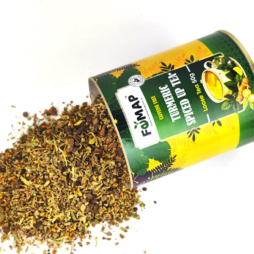 Loose turmeric spiced tea spilled from tin – FEMAP Turmeric Spiced‑Up Loose Tea