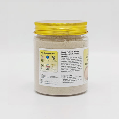 Jar of pink salt powder with a yellow lid on a white background
